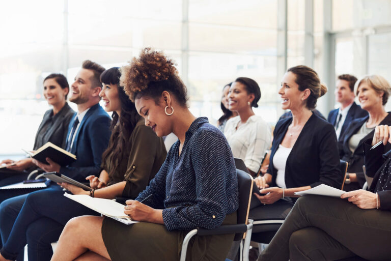 audience listening and taking notes